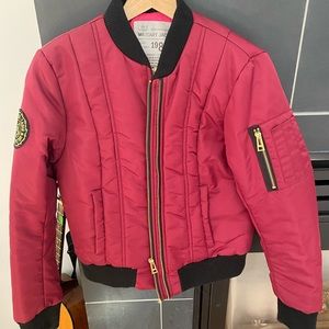 Bomber in maroon w/pink lining. Super warm, great quality. Now too small for me.